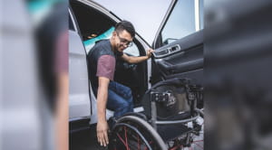 man using wheelchair accessible driving aids